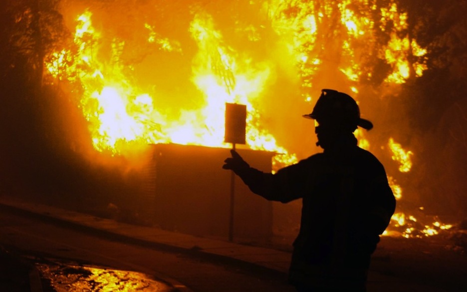 Bomberos trabajando en la extinción del fuego. (Felipe GAMBOA/AFP)